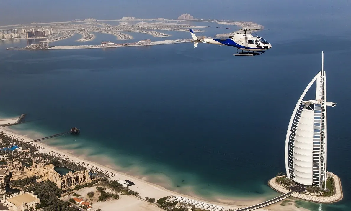 Helicopter flying past the Burj Al Arab and Palm Jumeirah